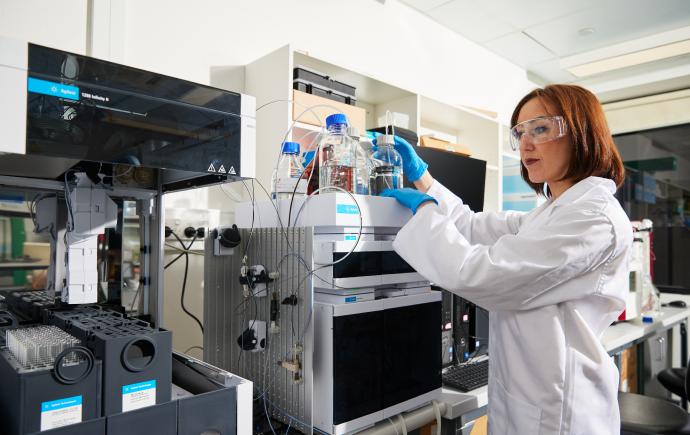 Laboratory scientist performing HPLC quality testing on research peptides.